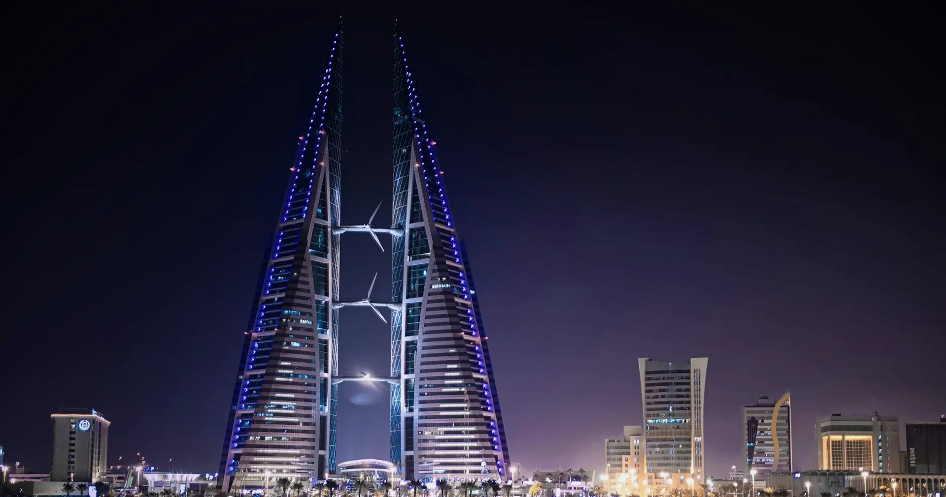 The Bahrain World Trade Center towers lit at night in Manama, Bahrain